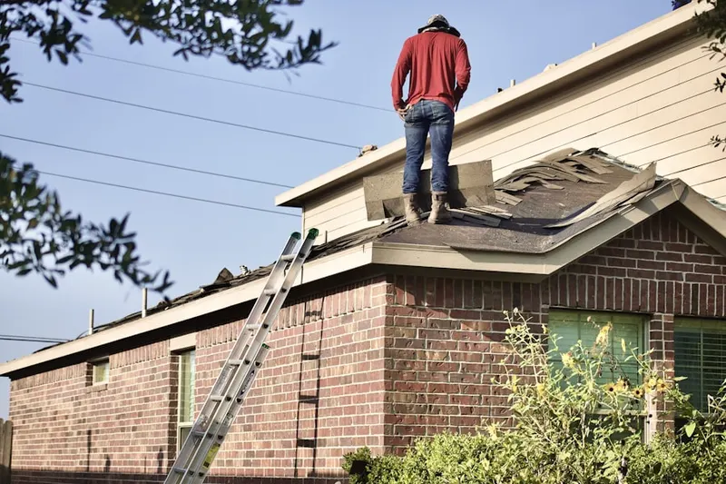Professional roofer working on a residential roof in Historic Biltmore Village